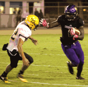 Norwalk High senior running back Jordan Thomas tries to hold off Cerritos High junior safety Ryder Eddy in last Friday night's 45-6 victory by the Lancers. Thomas led Norwalk with 83 yards on 13 carries and scored a pair of first half touchdowns. He was also crowned Norwalk's Homecoming King.  PHOTO BY ARMANDO VARGAS, Contributing photographer 