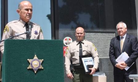 Los Angeles County Sheriff Lee Baca, Detective Mark Christiansen was presented with a Extraordinary Meritorious Service Award from Tom Levin (right), a member of the Board of Directors of MedicAlert on Tuesday in Norwalk.