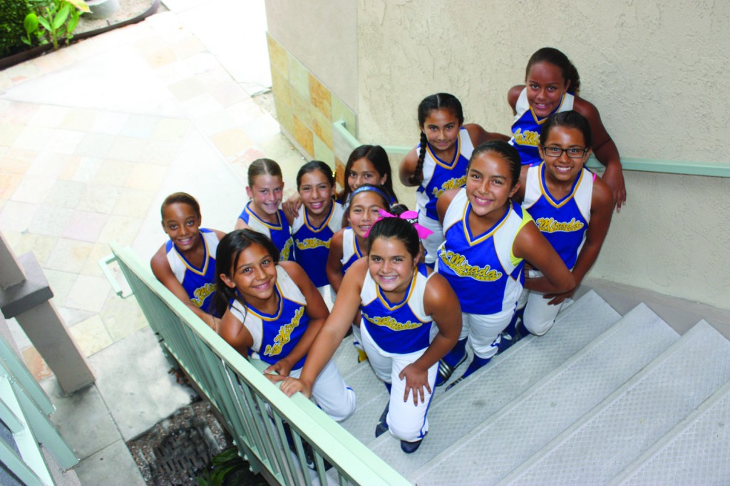 Members of the La Mirada Girls Softball Association poise at Hews Media Group – Community Newspaper offices in Cerritos on Wednesday afternoon.  The team needs to raise $11,000 in the next three weeks in order to head to Arizona to compete in a national championship tournament.  All of the team members are 10 years of age or younger, and all attend local schools in the La Mirada area.  Randy Economy Photo