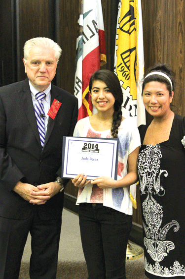 La Mirada Mayor Larry Mowles (left) presents certificate to Jade Perez of La Mirada High School (center) for 1st Place in her age group. At right is Perez'  teacher Catherine Guerra.
