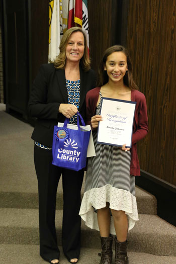 Mayor Deal presents a certificate to Natalie Gutierrez of Los Coyotes Middle School for First Place in her age group for the 2015 Bookmark Contest