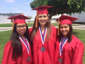 (From left to right) John Glenn High School graduates Kathleen Medrano, Destiny Enriquez and Monique Ramos pose at their commencement ceremony.