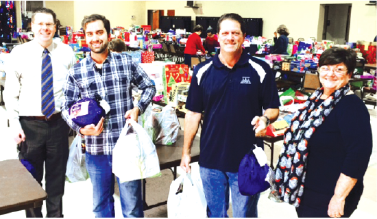  Members of the La Mirada Rotary Club donated more than $1,000 of complete holiday dinners for 34 families to the Good Sam Pantry at Beatitudes Church in La Mirada.  Pictured are (l to r): Russell Hall, Zurich Lewis, John Lewis and Pantry Coordinator Carmen Rawson. 